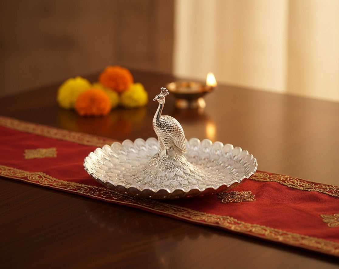 Art N Soul large German silver peacock serving bowl with intricate tail feathers on a red table runner