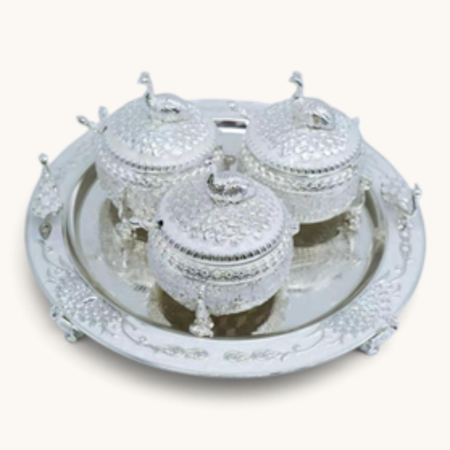 Art N Soul 3-piece German silver serving bowl set with decorative peacock lids on a matching round tray.